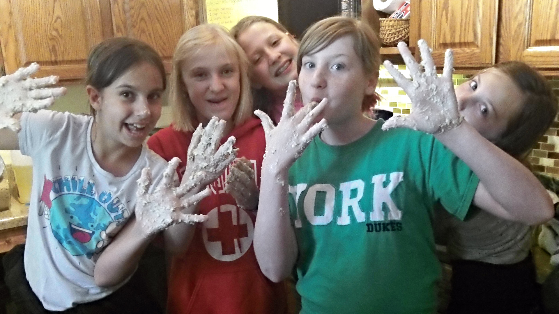5 youths messy from baking.