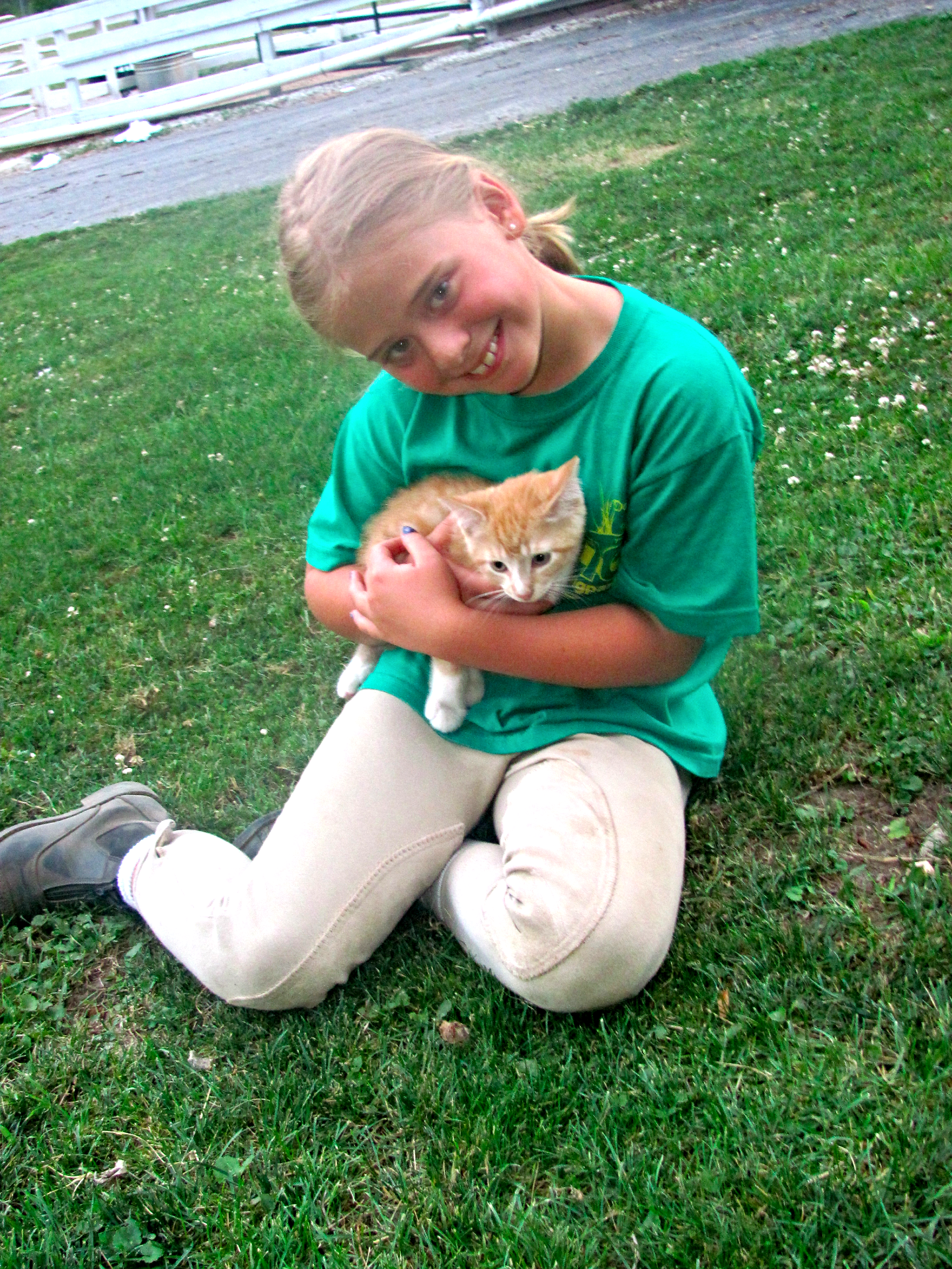 A young child holding a cat.