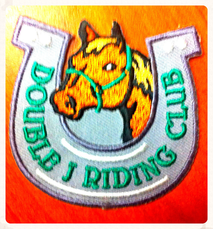 Double J Riding Club badge.